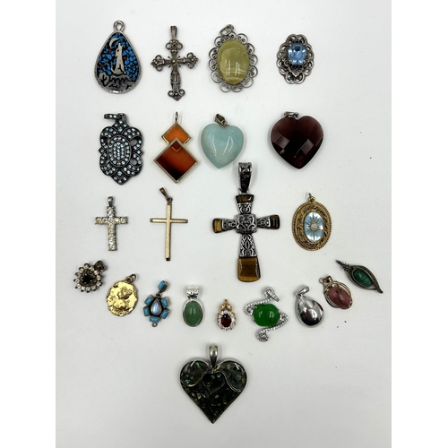 2114 - A collection of gemstone set pendants to include tiger's eye, topaz, garnet, turquoise and moonstone... 