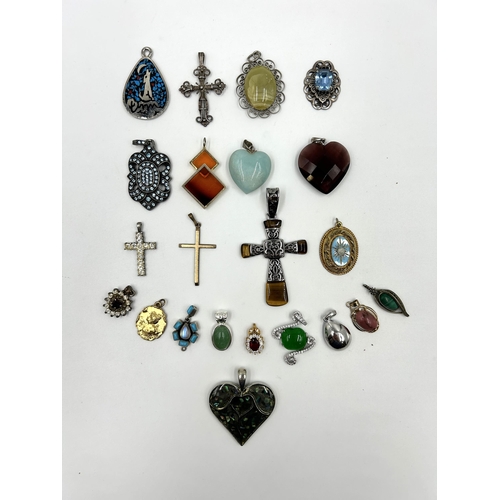 2114 - A collection of gemstone set pendants to include tiger's eye, topaz, garnet, turquoise and moonstone... 