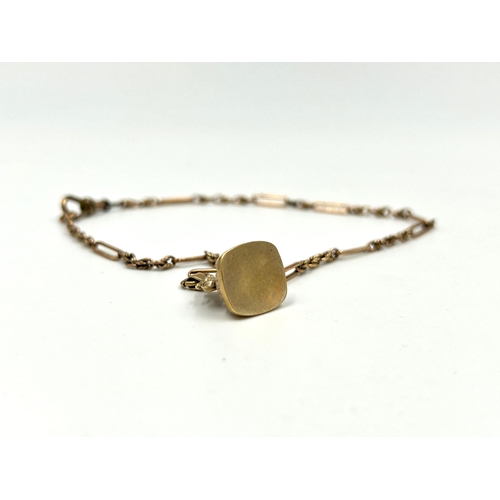 2128 - An antique hallmarked 9ct gold bracelet with hallmarked Birmingham 9ct gold fob seal charm - approx.... 