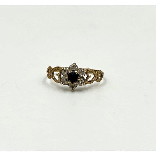 2144 - A hallmarked 9ct gold sapphire and clear gemstone floral cluster dress ring with heart shaped motifs... 