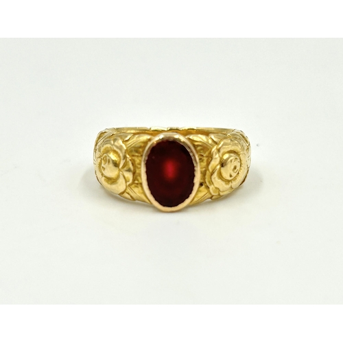 2150 - A yellow metal red stone set solitaire ring, size M - approx. gross weight 10.6g