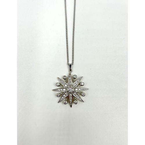 2156 - A hallmarked 18ct white gold diamond set star pendant necklace with central round brilliant cut diam... 