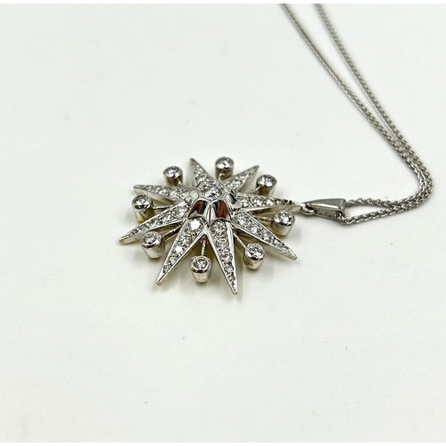 2156 - A hallmarked 18ct white gold diamond set star pendant necklace with central round brilliant cut diam... 