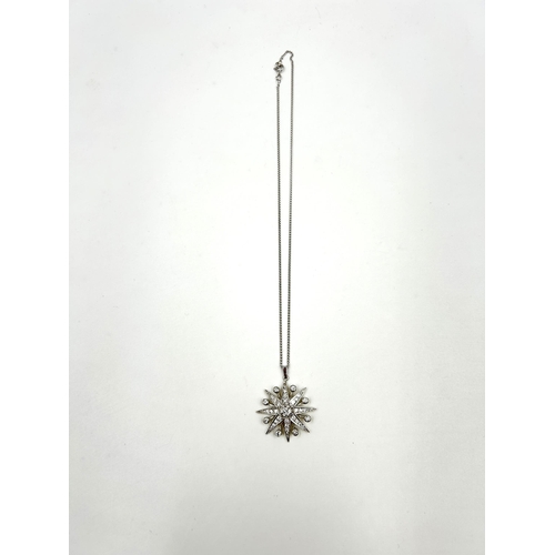 2156 - A hallmarked 18ct white gold diamond set star pendant necklace with central round brilliant cut diam... 