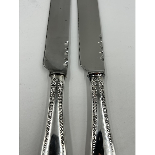 2240 - Two hallmarked Dublin silver handled cake knives, one cased