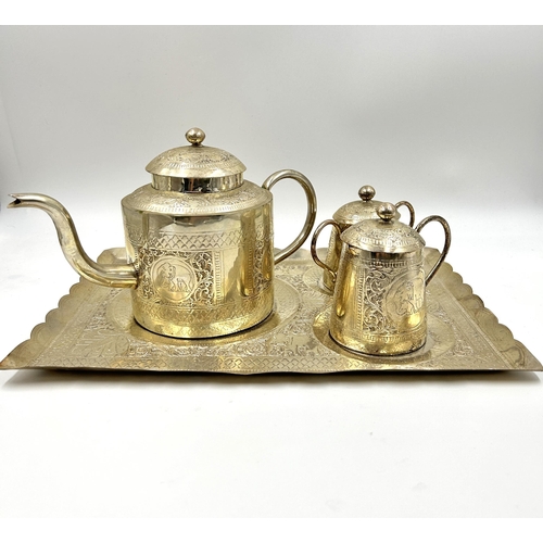 2244 - An Indian white metal four piece tea set with engraved elephant design - approx. gross weight 1026g