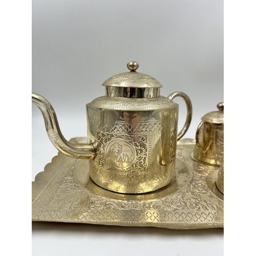 2244 - An Indian white metal four piece tea set with engraved elephant design - approx. gross weight 1026g