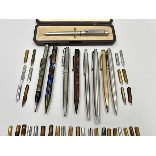 2264 - A collection of writing instruments and accessories to include two Parker retractable ballpoint pens... 