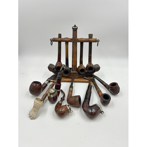 2279 - A 'Tallent' hand made oak HMS Victory novelty pipe stand with twelve smoking pipes to include Pipema... 