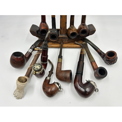 2279 - A 'Tallent' hand made oak HMS Victory novelty pipe stand with twelve smoking pipes to include Pipema... 