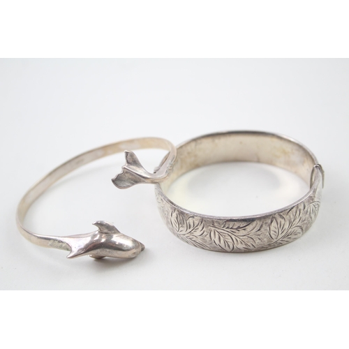 2104 - Two hallmarked sterling silver bangles, one dolphin design and one foliate etched, patent no. 897224... 