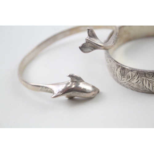 2104 - Two hallmarked sterling silver bangles, one dolphin design and one foliate etched, patent no. 897224... 