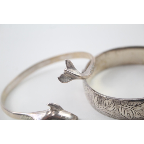 2104 - Two hallmarked sterling silver bangles, one dolphin design and one foliate etched, patent no. 897224... 