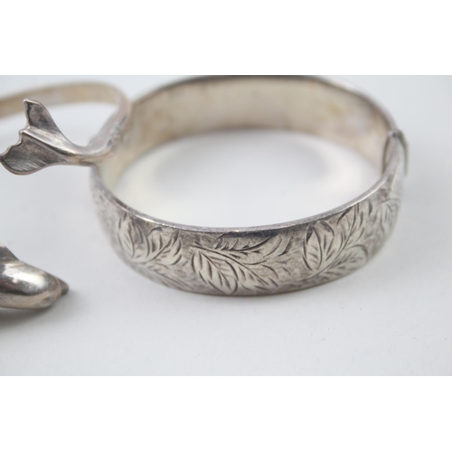 2104 - Two hallmarked sterling silver bangles, one dolphin design and one foliate etched, patent no. 897224... 