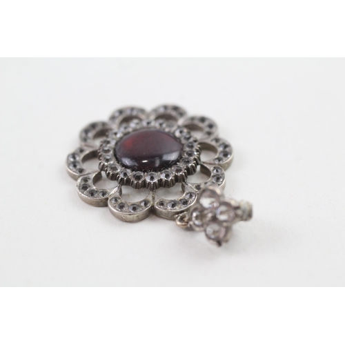 2105 - An antique sterling silver paste and red stone set floral pendant - approx. gross weight 5g