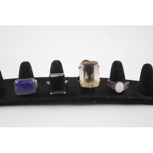 2111 - Four sterling silver gemstone set rings to include opal, lapis lazuli etc. - approx. gross weight 29... 