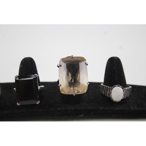 2111 - Four sterling silver gemstone set rings to include opal, lapis lazuli etc. - approx. gross weight 29... 