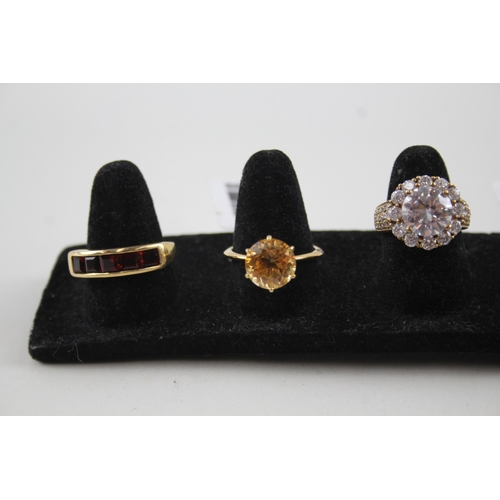 2121 - Six .925 gilt silver gemstone set rings to include CZ, topaz, garnet etc. - approx. gross weight 18g