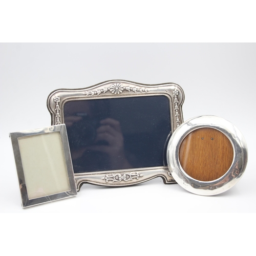 2205 - Three hallmarked sterling silver photo frames - largest approx. 14cm high x 18cm wide