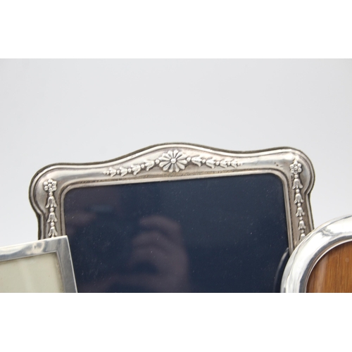 2205 - Three hallmarked sterling silver photo frames - largest approx. 14cm high x 18cm wide