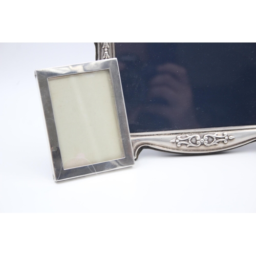 2205 - Three hallmarked sterling silver photo frames - largest approx. 14cm high x 18cm wide