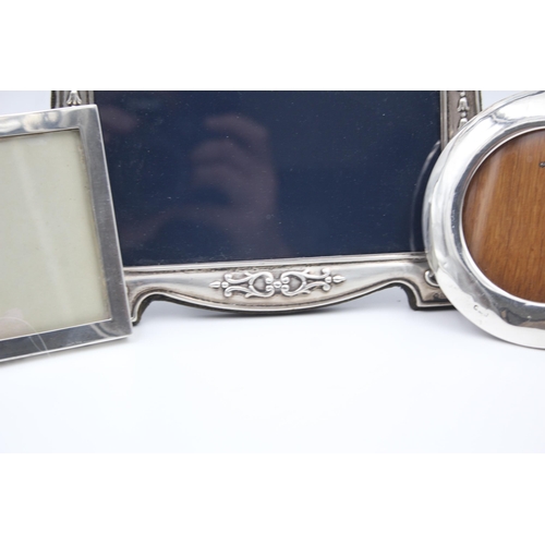 2205 - Three hallmarked sterling silver photo frames - largest approx. 14cm high x 18cm wide