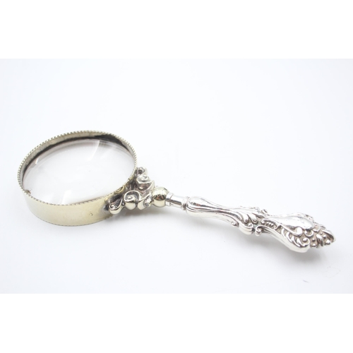 2228A - A hallmarked sterling silver handled magnifying glass - approx. 17cm long