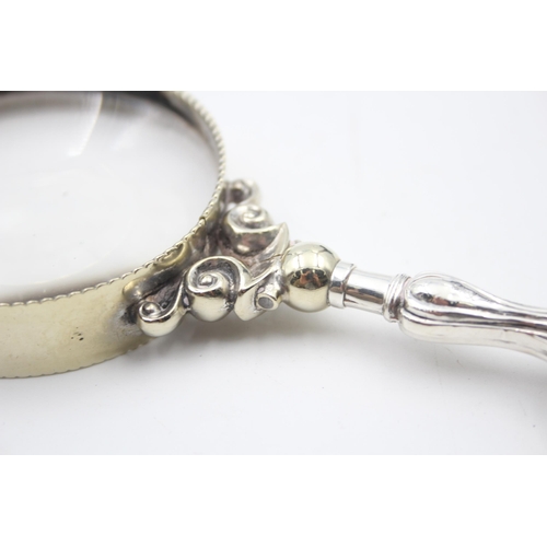 2228A - A hallmarked sterling silver handled magnifying glass - approx. 17cm long