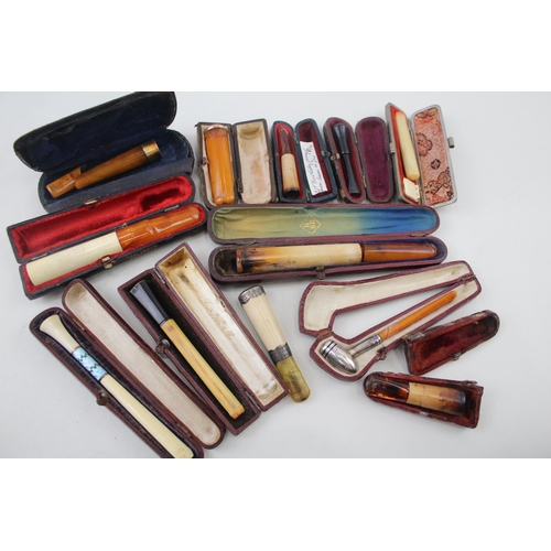 2252 - Twelve cheroot holders to include silver banded meerschaum, amber etc.