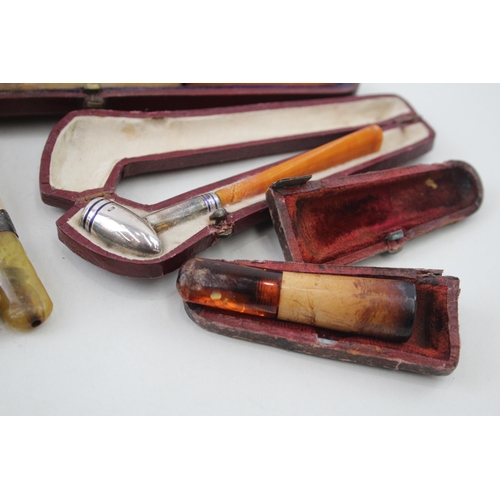 2252 - Twelve cheroot holders to include silver banded meerschaum, amber etc.