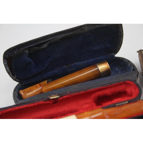 2252 - Twelve cheroot holders to include silver banded meerschaum, amber etc.