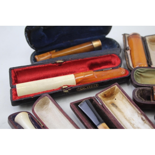 2252 - Twelve cheroot holders to include silver banded meerschaum, amber etc.