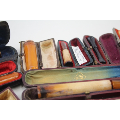 2252 - Twelve cheroot holders to include silver banded meerschaum, amber etc.