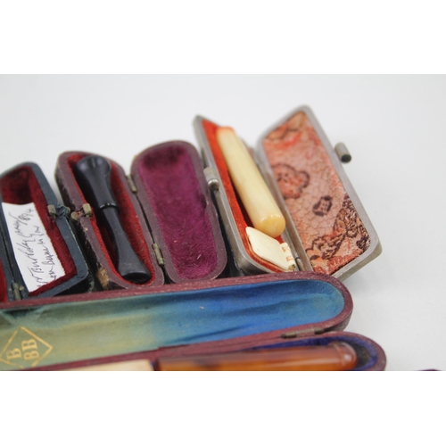 2252 - Twelve cheroot holders to include silver banded meerschaum, amber etc.