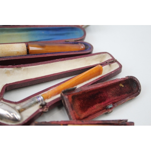 2252 - Twelve cheroot holders to include silver banded meerschaum, amber etc.