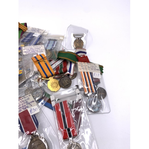 2310 - A collection of miniature military medals to include South African, Polish, United States etc.