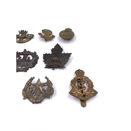 2311 - Eleven military cap badges to include Royal Army Medical Corps, South African etc.