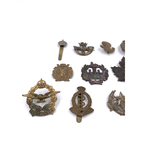 2311 - Eleven military cap badges to include Royal Army Medical Corps, South African etc.