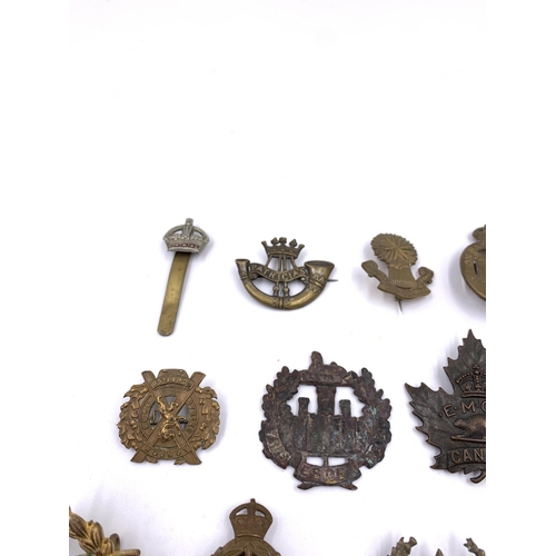 2311 - Eleven military cap badges to include Royal Army Medical Corps, South African etc.