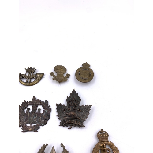 2311 - Eleven military cap badges to include Royal Army Medical Corps, South African etc.