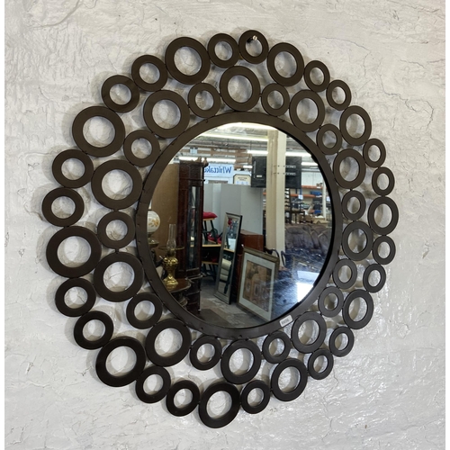 219 - A modern metal circular decorative wall mirror - approx. 68cm in diameter