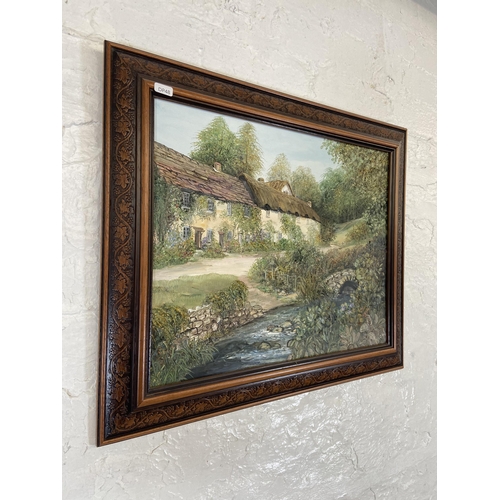 231 - A 20th century framed Ann Cellia oil on board of a village scene - approx. 51cm high x 61cm wide