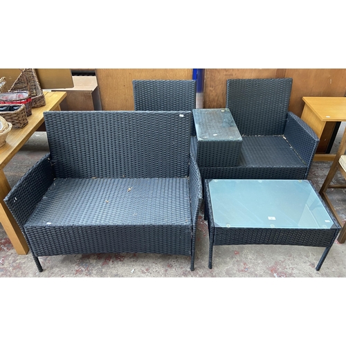 173 - Three pieces of plastic rattan effect garden furniture, one two seater love seat, one two seater sof... 