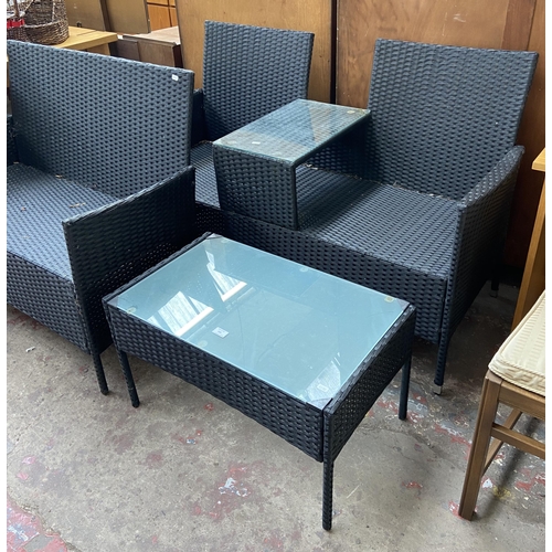 173 - Three pieces of plastic rattan effect garden furniture, one two seater love seat, one two seater sof... 