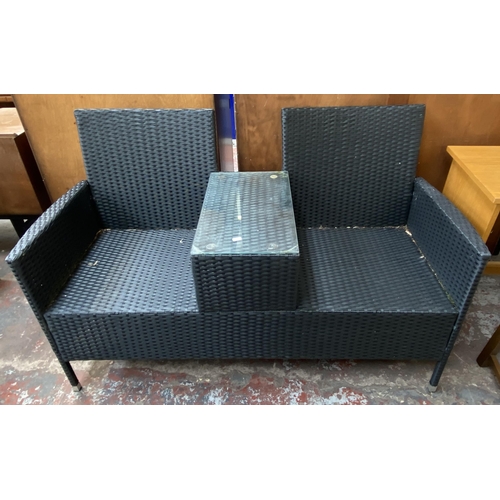 173 - Three pieces of plastic rattan effect garden furniture, one two seater love seat, one two seater sof... 