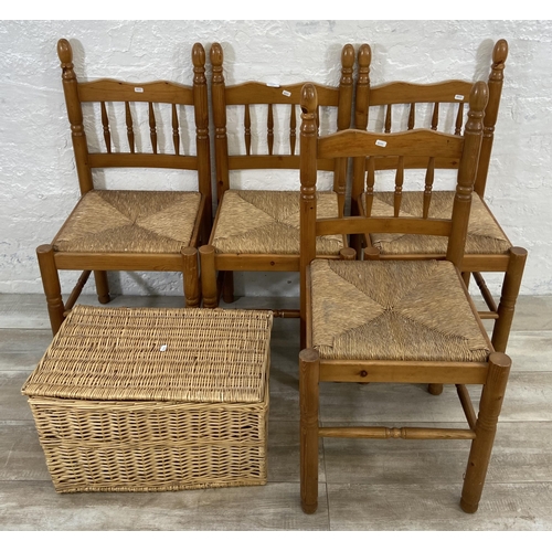 175 - Five pieces of furniture, four pine and rush seated dining chairs and one wicker basket