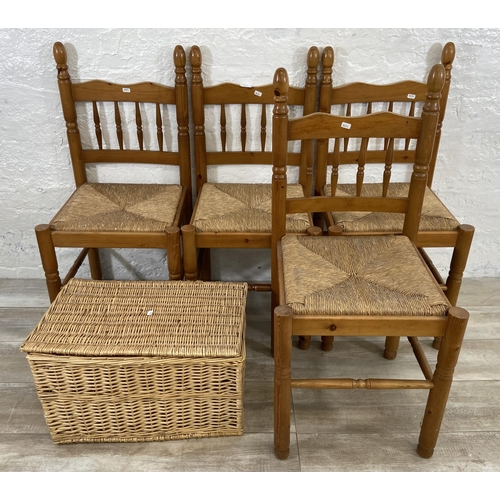 175 - Five pieces of furniture, four pine and rush seated dining chairs and one wicker basket