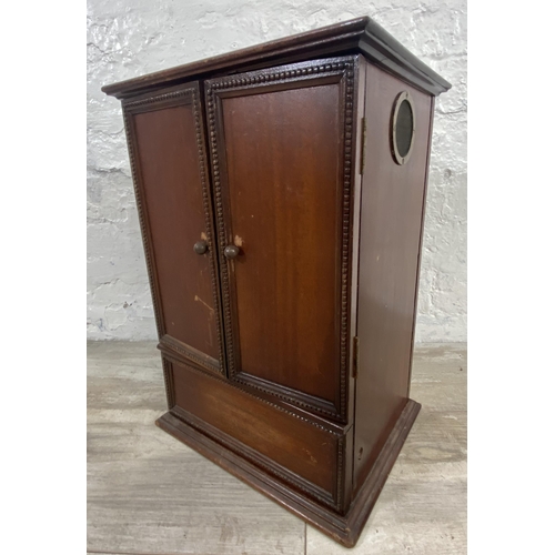 192 - An early 20th century mahogany two door smoker's cabinet - approx. 42cm high x 30cm wide x 23cm deep