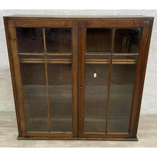 193 - Two pieces of oak furniture, one early 20th century glazed book case top and one barley twist side t... 