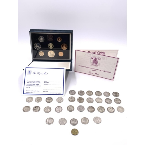 2260 - A collection of coins to include approx. 160g of British 92.5% silver shillings, cased 1984 Royal Mi... 